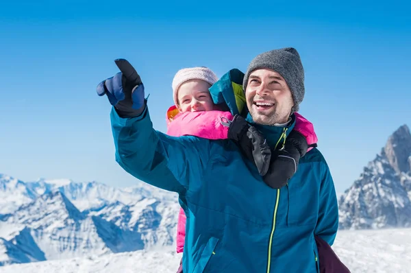 Vater huckepack Tochter im Winterurlaub — Stockfoto