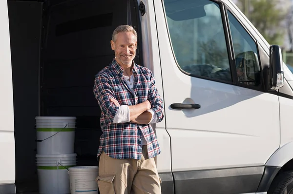 Painter standing against van