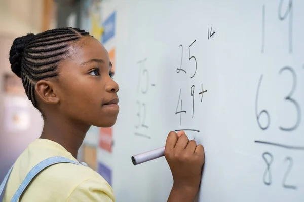 Menina resolvendo adição matemática — Fotografia de Stock