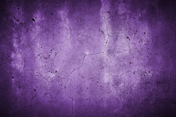 cracked concrete wall with fine fissures background texture, colored purple
