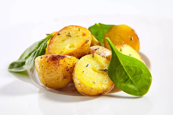 Baked potatoes with herbs dish closeup — Stock Photo, Image