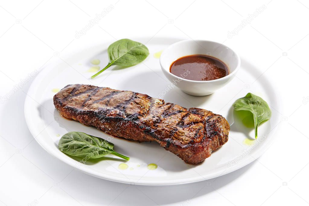 Striploin steak with sauce close up