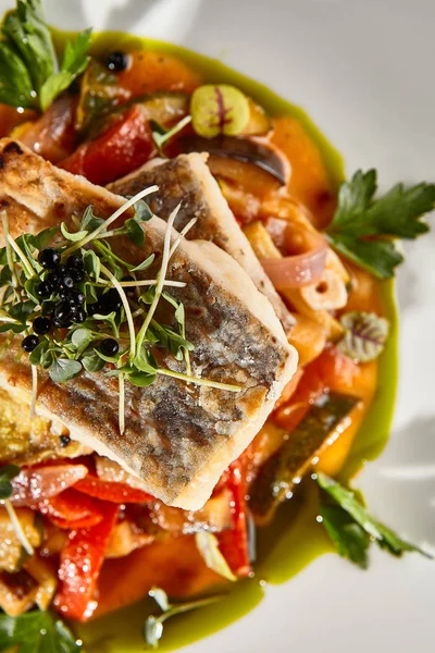 Pollock fish fillet with vegetables on white plate — Stock Photo, Image