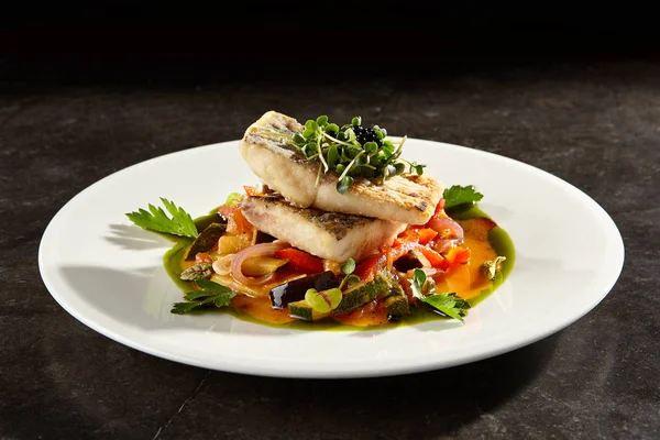 Pollock fish fillet with vegetables on white plate — Stock Photo, Image