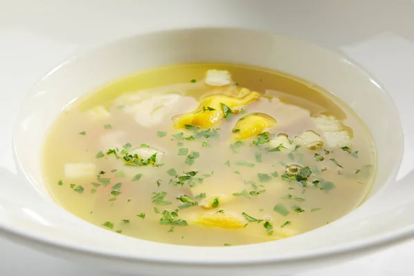 Chicken Bouillon with Tortellini Pasta in White Restaurant Bowl — Stock Photo, Image