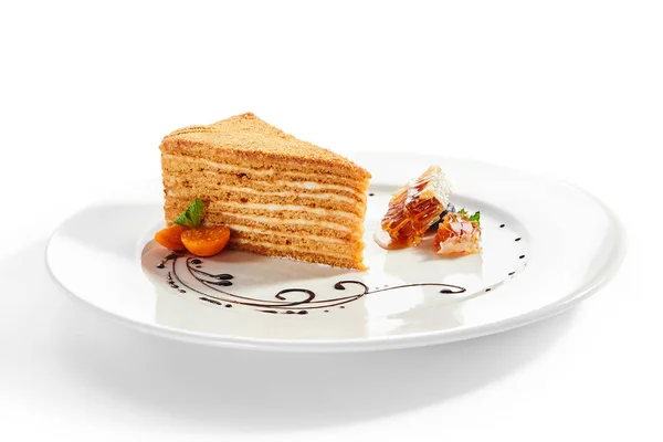 白いプレートにメディボクスライス ロシアの伝統的な焼きパイを提供 レストランの装飾デザート クリームとハニーサイドビューで層おいしいタルト 甘いもの菓子 — ストック写真