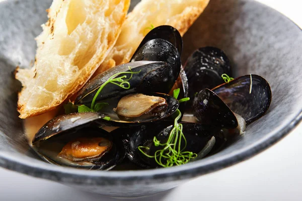 バゲットスライスとマッセル 焼きたての牡蠣にパンを添えます ハーブの組成物で飾られたシーフードレストラン食品 海の珍味 プレートの地中海料理 — ストック写真