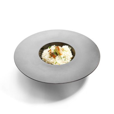 Porcini risotto yakın çekim görüntüsü. Beyaz mantarlı lezzetli pilav. Geleneksel İtalyan yemekleri. Taze yeşillikle nefis bir yemek. Restoran yemeği, aşçılık kompozisyonu. Avrupa tarifi