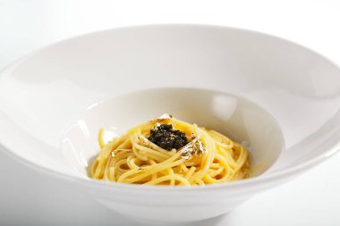 Beluga havyarlı spagetti. Geleneksel İtalyan mutfağı servis edildi. Balık havyarlı makarna ve tereyağı sosu tabakta. İtalyan mutfağı. Restoran yemekleri bölümü beyaz arka planda izole edilmiş.