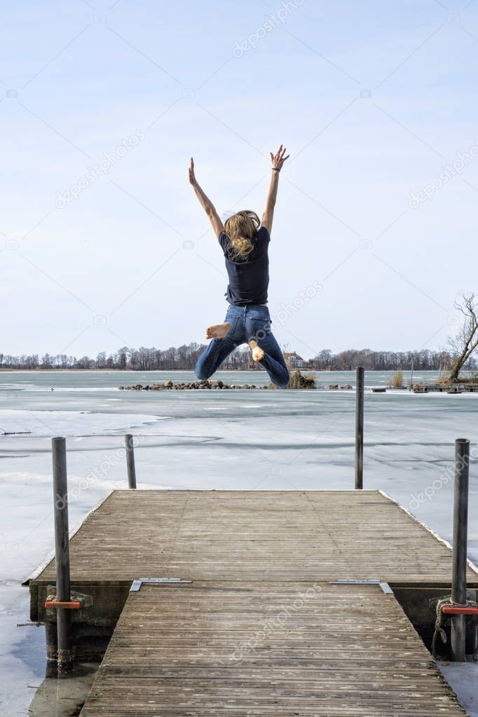 Kid jumping by the water