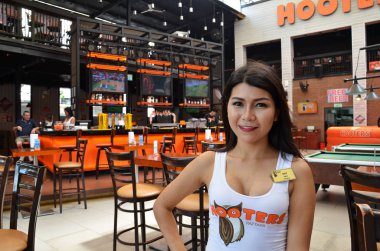 Hooters kızı Hooters restoranı fotoğraf için poz veriyor