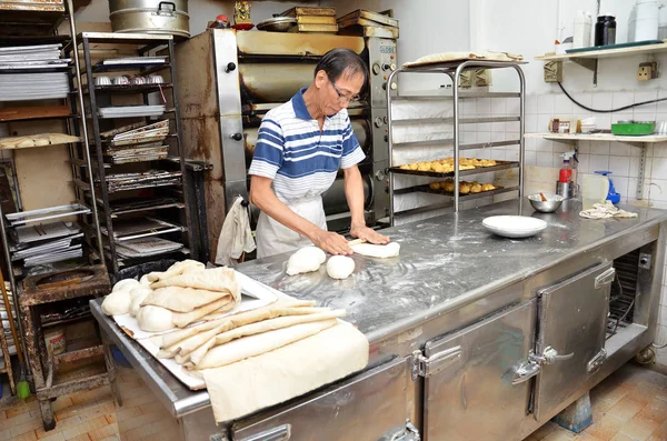 Chef forming dough in order to prepare bread — Stock Photo, Image