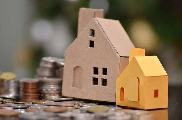 Paper house and stacks of coins standing — Stock Photo, Image