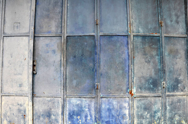 Vintage and old blue metal door with rectangular pattern