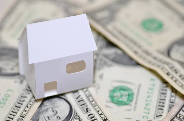 Miniature paper made house stand on  money — Stock Photo, Image