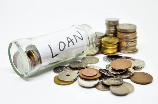 Loan lable in a glass jar with coins spilling out — Stock Photo, Image