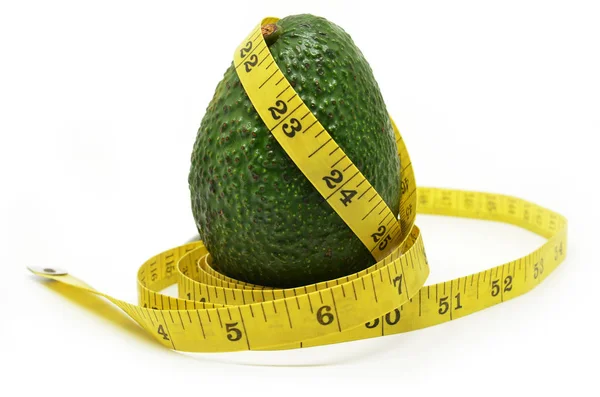 Avocado with measuring tape — Stock Photo, Image