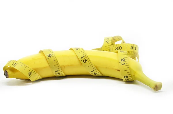 Banana with tape measure — Stock Photo, Image