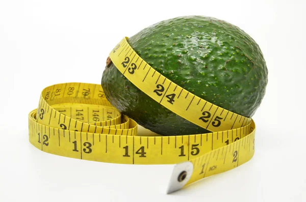 Avocado and measure tape — Stock Photo, Image