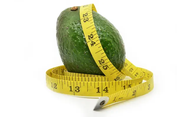 Avocado and measure tape — Stock Photo, Image