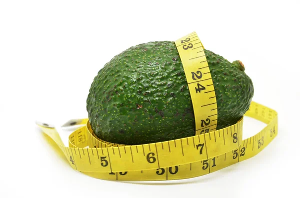 Avocado with measuring tape — Stock Photo, Image