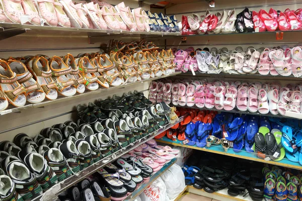 Rows of stylish children shoes on a rack — Stock Photo, Image