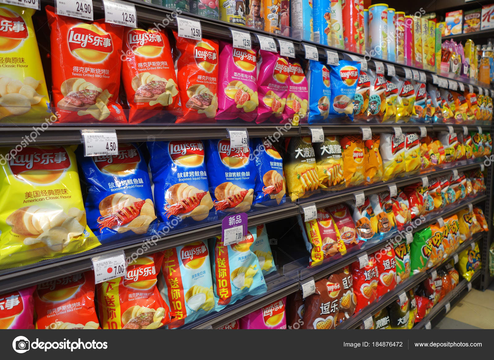Potato chips and snacks in packaging for sale Stock Editorial Photo