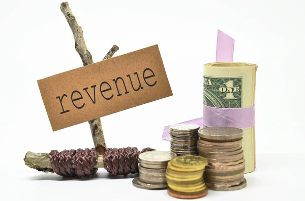 Coins and money with revenue label — Stock Photo, Image