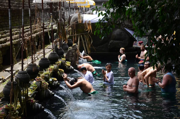 İnsanlar, volkanik bir kaynaktan gelen kutsal suda banyo yaparlar.