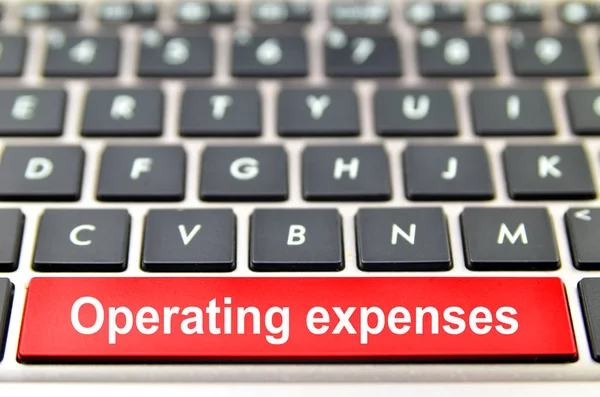 Operating expenses word on computer space bar — Stock Photo, Image