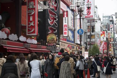 Dotonbori ar caddesinde yürüyen bir turist.