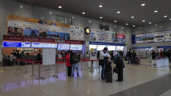 Unidentified male buys ticket from train counter at Kansai Airpo — Stock Photo, Image