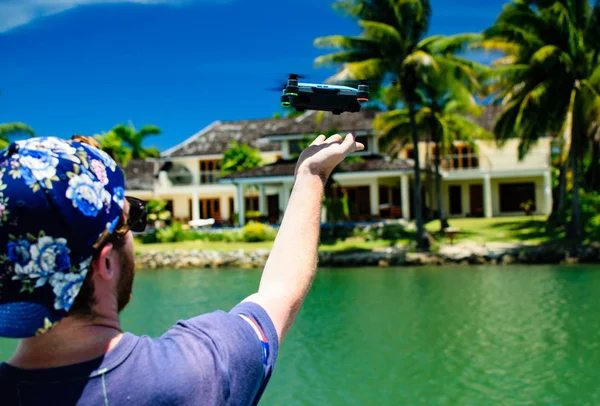 Man Flying a Drone over Water