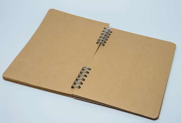 Opened brown plain notebook with white background and selective focus — Stock Photo, Image