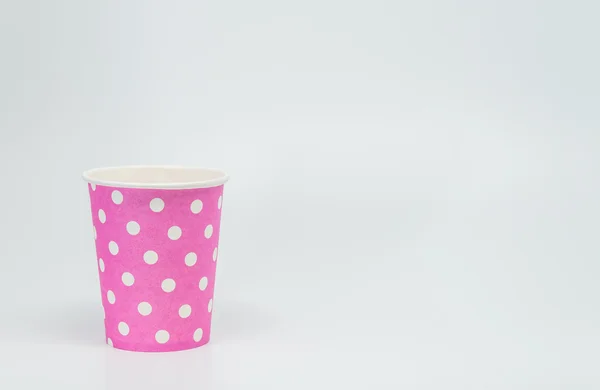 White dot pattern on Pink paper cup with white background and selective focus — Stock Photo, Image