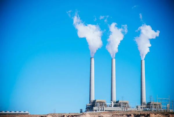 Coal power plant energy and smoke out from stack with blue sky background