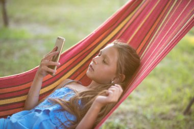 Çocuk parkındaki küçük kız. Hamaktaki küçük kız