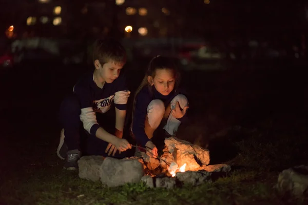 夜のたき火の近くの子供たち — ストック写真