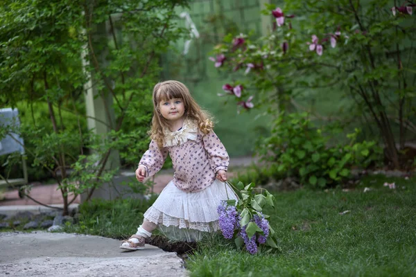 带着一束野花的小女孩 带着花的女孩花园里一个女孩的画像 — 图库照片