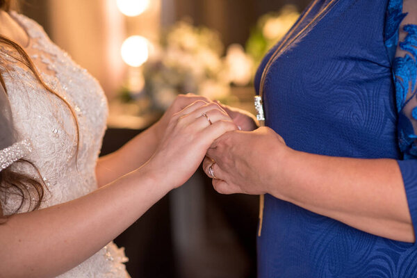 bride and groom holding hands. mothers Day