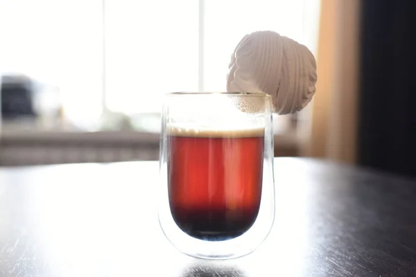 glass of beer in the snow. glass of tea