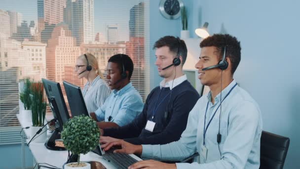 Medium shot of Diverse team of call center customers looking to the camera and smiling — Stock Video