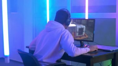 Back view of young gamer winning online game