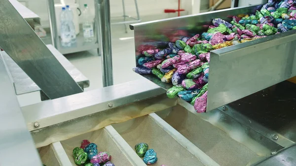 Candy factory. Sweets spilling from conveyor.