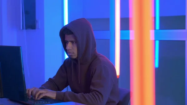 African hacker dressed in hoodie working on the computer — Stockfoto