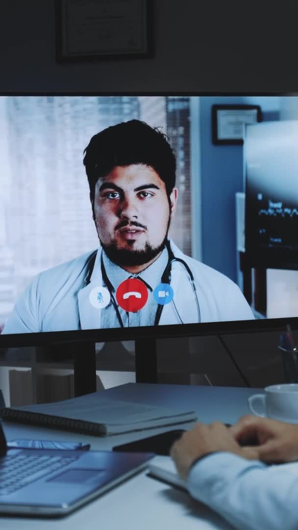 Back view of young man making video call with head doctor about coronavirus spreading — Stock Video