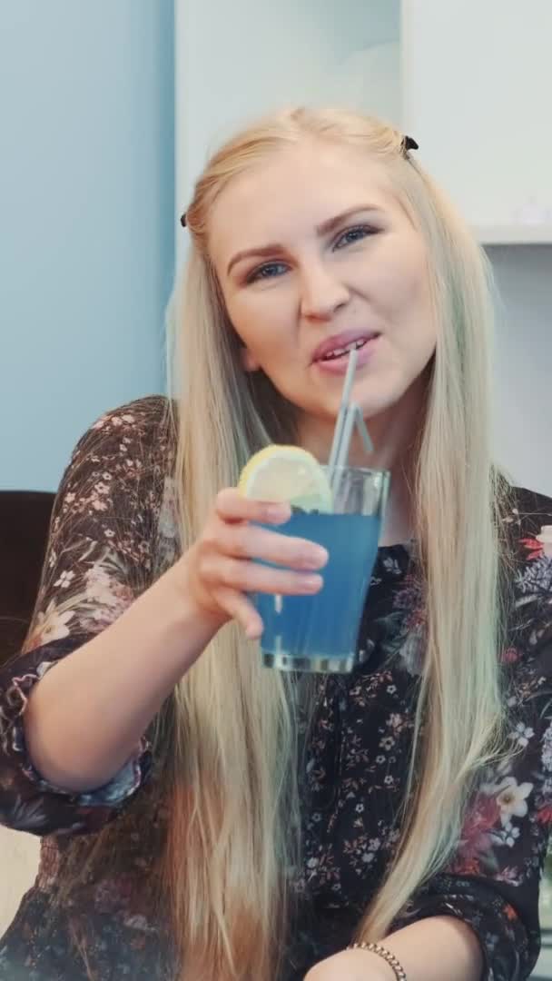 Nice girl is wishing "Happy New Year" with a glass of drink — Stock Video