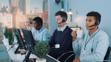 Customer support agent drinks tea and is bored.