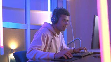 Cheerful african guy winning online shooter in internet championship of online games