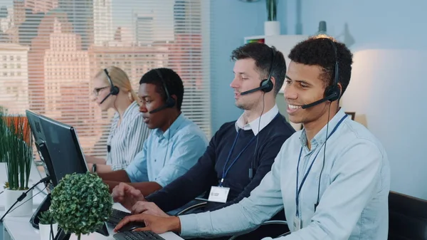 Multiracial call center agent feeling exhausted and broken-down after telephone call with the client.